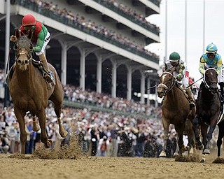 In this May 7, 2011 file photo, John Velazquez, left, rides Animal Kingdom, to victory during the 137th Kentucky Derby horse race at Churchill Downs in Louisville, Ky. The anticipation of a Triple Crown try was building as Kentucky Derby winner Animal Kingdom was closing in on Shackleford in the final yards of the Preakness Stakes. The colt's gallant bid, however, came up short - by a mere half length. (AP Photo/David J. Phillip, File)