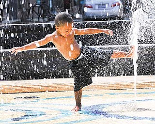 Damien Sheffield, 2, plays in a water fountain in Washington, Wednesday, June 8, 2011. The official start of summer is still two weeks away, but much of the nation is sweating through near-record temperatures, with heat advisories and warnings issued across the Northeast, mid-Atlantic and upper Midwest. (AP Photo/Alex Brandon)