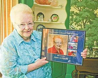 Jean Marie Schlecht of Warren was inducted last month into the Ohio Senior Citizens Hall of Fame. Schlecht, holding the plaque she received from the Ohio Department of Aging, was recognized for more than a half-century of volunteer work in Trumbull County.