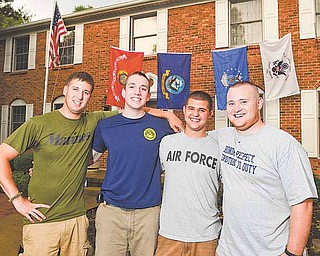 Four close friends from Boardman, from left, Mark Kuntzman of the Marine Corps, Erik Kuff el of the Navy, Andrew Mitchell of the Air Force Reserves and Zak Dietz of the Coast Guard, gathered for a reunion Friday at Dietz’s home.