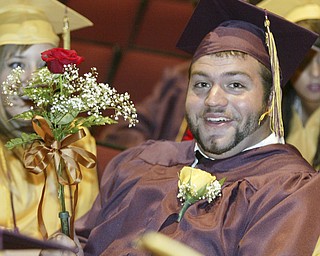 William D. Lewis The Vindicator South Range graduate Nick Parks hams it up with a female classmates bouquet before commencement Saturday at the HS.
