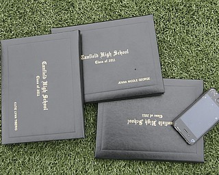 ROBERT K. YOSAY | THE VINDICATOR --..Sign of the times as diplomas and an IPHONE lay on the turf..Canfield High School 2011 graduation at the Stadium - .. -30-..(AP Photo/The Vindicator, Robert K. Yosay)