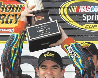 Jeff Gordon poses with the trophy in victory lane after winning the NASCAR Sprint Cup Series auto race, Sunday, June 12, 2011, in Long Pond, Pa. (AP Photo/Russ Hamilton Sr.)