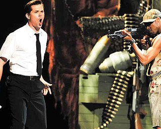 Andrew Rannells, left, and the cast of "The Book of Mormon" perform during the 65th annual Tony Awards, Sunday, June 12, 2011 in New York. (AP Photo/Jeff Christensen)