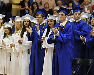 Poland High School seniors give a standing ovation to the commencement speaker Poland High School teacher William Snyder.