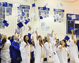 Poland High School seniors throw their caps in the air after graduating Sunday afternoon.