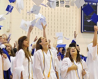 Poland High School seniors Danielle Mullis, Lidia Mowad, Sarah Lankitus throw their caps in the air after graduating.