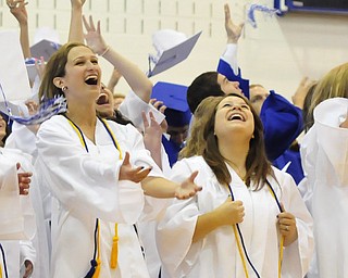 Poland High School Senior's Danielle Mullis, and Lidia Mowad throws their caps in the air after graduating.