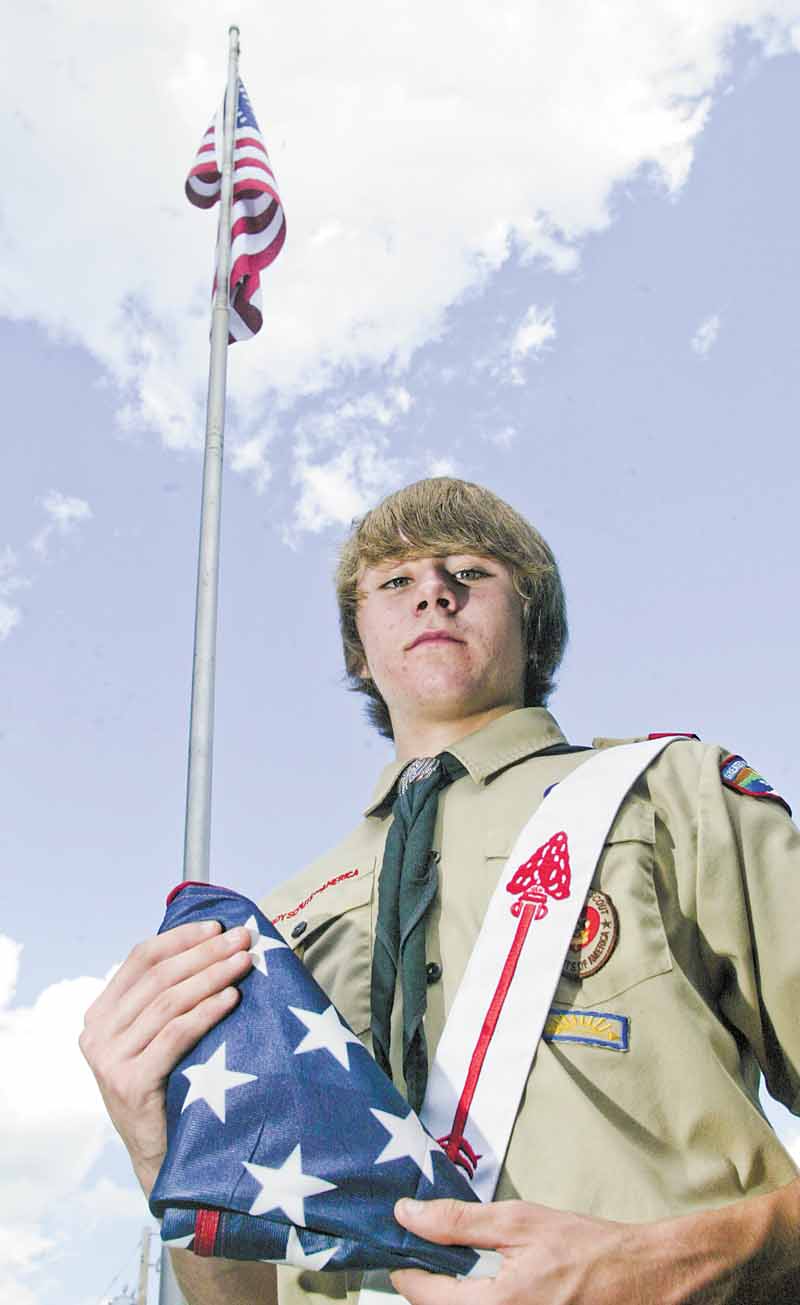 Eagle Scout candidate Greg Haylett, 16, said the lighted flagpole he’s planning to install at Poland Township Park will also serve as a 9/11 memorial. The pole behind him is at Poland United Methodist Church.