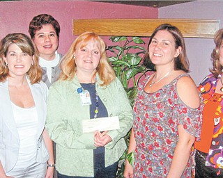 JoAnn Stock, director of development for Akron Children’s Hospital Mahoning Valley, holds a check donated by committee members of the Mahoning County Medical Society Alliance, from left to right, Cassie Calderon, Paula Jakubek, Tammy Engle and Carol Sankovic. Not pictured is committee member Shelly Barton.