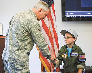 Cameron receives congratulations from by Air Force Reserve Col. Stephen J. “Fritz” Linsenmeyer, commander of the 910th and the Youngstown Air Reserve Station in Vienna. The Pilot for a Day program provides a day of activities at the 910th to children who live with a chronic or life-threatening disease or illness. 