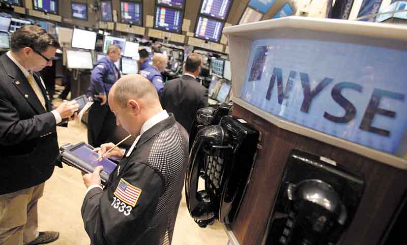 In this June 16, 2011 photo, traders work on the floor of the New York Stock Exchange. World markets fell Friday, June 17, despite positive economic data out of the U.S., as a political shake-up in Greece added to worries that the country might be forced to default on its debt. (AP Photo/Richard Drew)