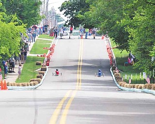 Soap box racers zip down West Main Street in Cortland. Area kids competed in the Greater Youngstown Area Soap Box Derby on Saturday for a chance to compete in the All-American Soap Box Derby Championships in Akron on July 23.