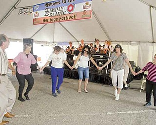 Taking part in a traditional Slavic dance to Tamburitza music are, from left, George Metzka, Libby Fil, Janine Mentzer, Lisa Nagy and Paula Horvath Festival attendees had a chance to dance to several Slavic-style bands.