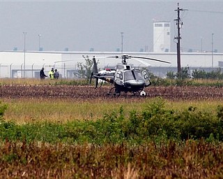 An Ohio Highway Patrol helicopter prepares to take off after landing near a double fatal air crash at the Rickenbacker Airport, Sunday, June 19, 2011. (AP Photo/Columbus Dispatch, Jeff Hinckley)