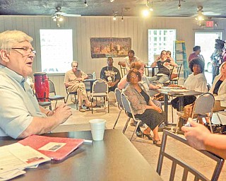 John R. Swierz, left, Youngstown’s 7th Ward councilman, takes part in the I.C.U. Block Watch meeting, which took place Monday night at The Metro Assembly of God youth facility on South Avenue. The weekend killing of a city teenager dominated the discussions at the meeting.