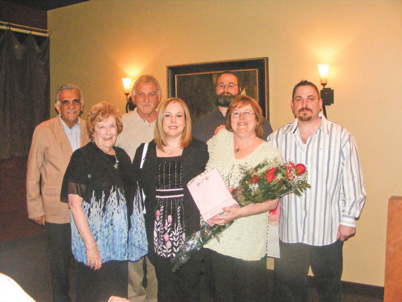 Cathy Pokrivnak, holding flowers, celebrates being named 2011 Woman of the Year by the Youngstown Charter Chapter of the American Business Women’s Association. With her are, front left, Mary Ann Rushton, her mother; Susan Carosella, her daughter; and back, from left, stepdad Gus Merola, husband John Pokrivnak, son Steve Baytos IV and son-in-law Ed Carosella.