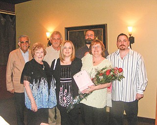 Cathy Pokrivnak, holding flowers, celebrates being named 2011 Woman of the Year by the Youngstown Charter Chapter of the American Business Women’s Association. With her are, front left, Mary Ann Rushton, her mother; Susan Carosella, her daughter; and back, from left, stepdad Gus Merola, husband John Pokrivnak, son Steve Baytos IV and son-in-law Ed Carosella.