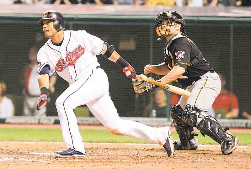 With Pittsburgh Pirates catcher Michael McKenry behind the plate, Cleveland Indians second baseman Orlando Cabrera watches his RBI hit in an interleague baseball game in Cleveland on Friday, June 17, 2011.   (AP Photo/Amy Sancetta)