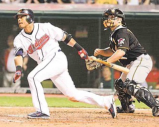 With Pittsburgh Pirates catcher Michael McKenry behind the plate, Cleveland Indians second baseman Orlando Cabrera watches his RBI hit in an interleague baseball game in Cleveland on Friday, June 17, 2011. (AP Photo/Amy Sancetta)