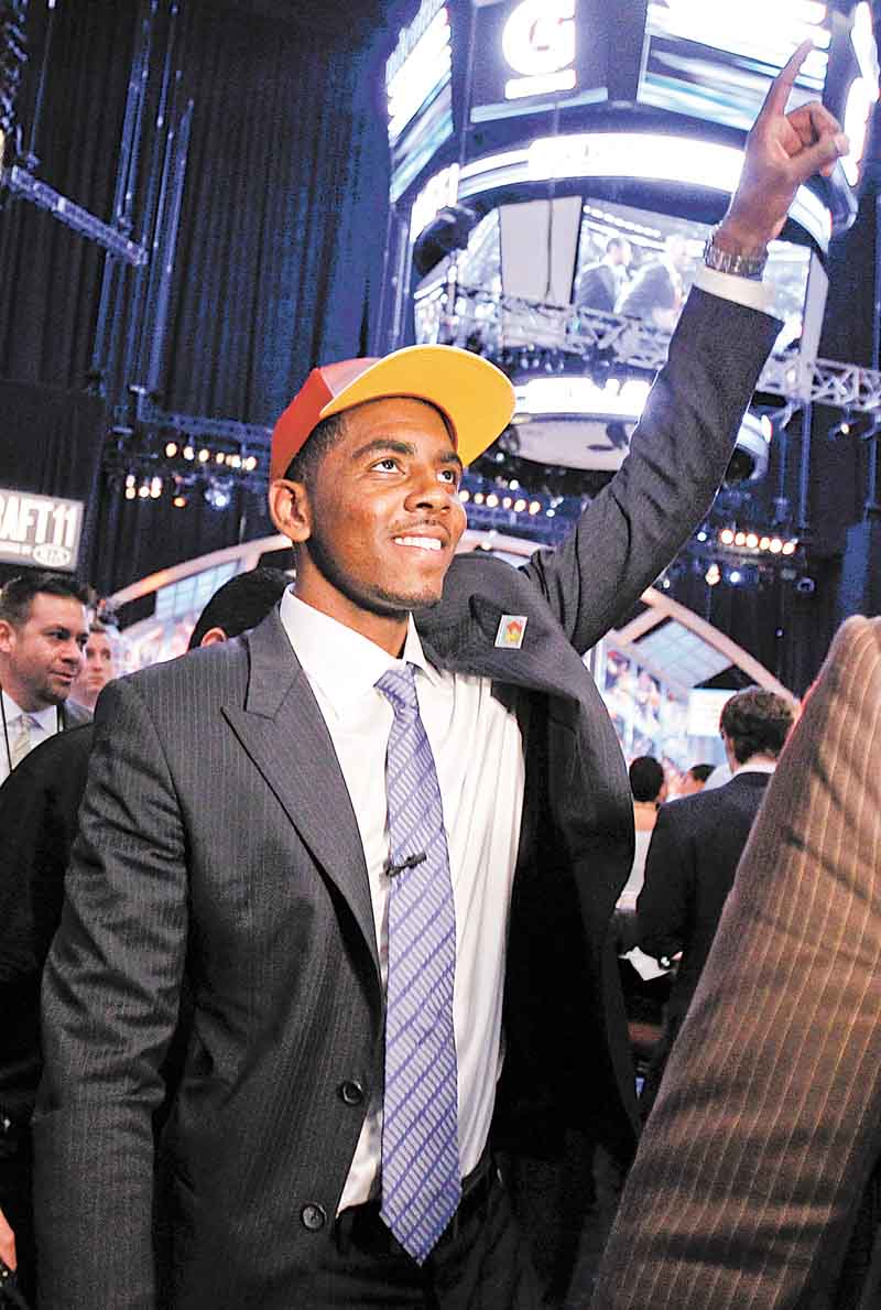 Kyrie Irving, a former Duke basketball player, gestures to the crowd after being selected with the No. 1 pick by the Cleveland Cavaliers during the NBA basketball draft, Thursday, June 23, 2011, in Newark, N.J. (AP Photo/Julio Cortez)