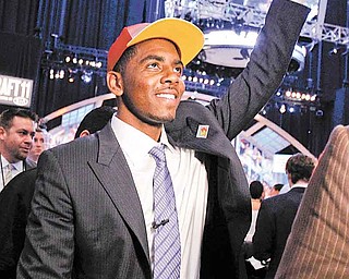 Kyrie Irving, a former Duke basketball player, gestures to the crowd after being selected with the No. 1 pick by the Cleveland Cavaliers during the NBA basketball draft, Thursday, June 23, 2011, in Newark, N.J. (AP Photo/Julio Cortez)