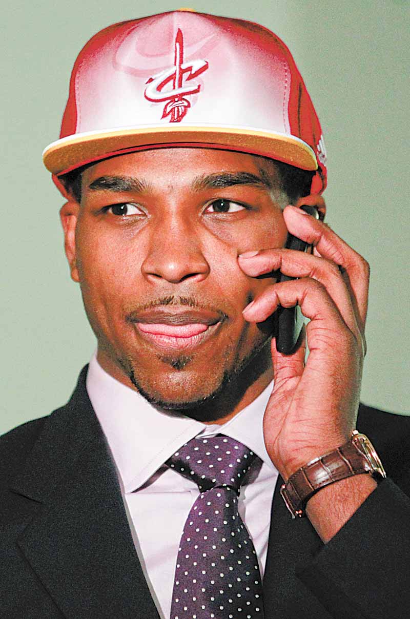 Texas' Tristan Thompson talks on a phone moments after being picked No. 4 by the Cleveland Cavaliers in the NBA basketball draft, Thursday, June 23, 2011, in Newark, N.J. (AP Photo/Julio Cortez)