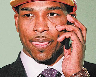 Texas' Tristan Thompson talks on a phone moments after being picked No. 4 by the Cleveland Cavaliers in the NBA basketball draft, Thursday, June 23, 2011, in Newark, N.J. (AP Photo/Julio Cortez)