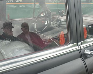 The Rollers members George Becker and Wayne Holcomb are seen in the reflection of Holcomb's Bel-Air. Members of the Cleveland car club were in Salem Friday for the Steel Valler Super Nationals.