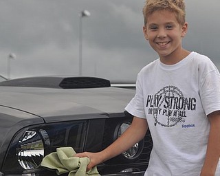 Joseph Paglia poses with his father's car Friday at the Steel Valley Super Nationals at the Quaker City Motorsports Park. The rain prevented racing Friday, the first day of the event.