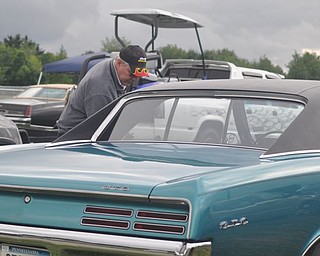 Denny Pevan gets into his GTO. An admitted 'Pontiac fanatic,' Pevan owns two GTOs which he and his wife, Linda, race.