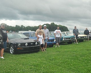 The Gear Busters car club from New Castle, Pa. poses with their cars Friday at the Steel Valley Super Nationals. Member Denny Pevan explains the club is a family that goes everywhere and does everything together. Next, they'll be at Back to the 50s in their hometown.