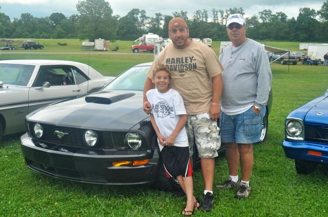 Three generations of racing: Joseph, James and Lou Paglia pose with James Paglia's 2007 Ford Mustang GT at the Steel Valley Super Nationals at the Quaker City Motorsports Park. The trio is part of the Gear Buster's car club.