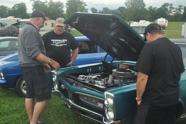 Members of the Gear Busters car club look at Denny Pevan's 1967 Pontiac GTO during the Steel Valley Super Nationals Friday at Quaker City Raceway.