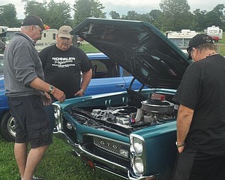Members of the Gear Busters car club look at Denny Pevan's 1967 Pontiac GTO during the Steel Valley Super Nationals Friday at Quaker City Raceway.