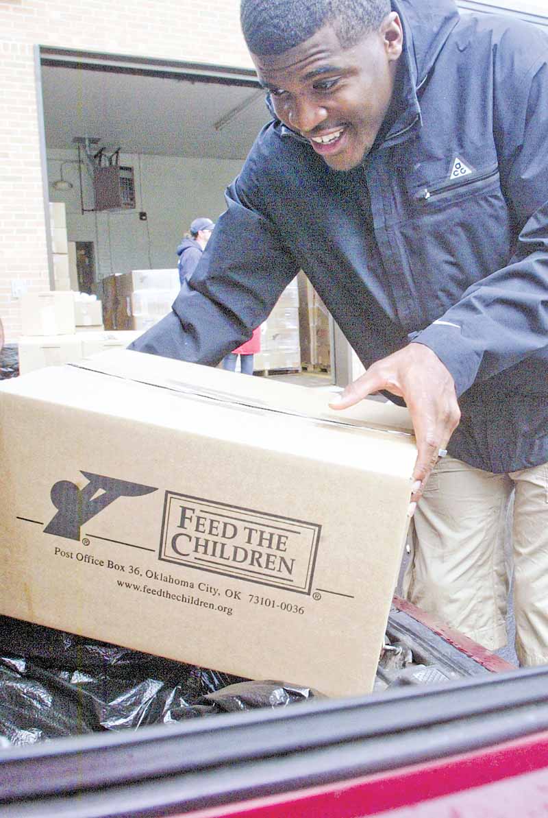 Brad Smith, a wide receiver and kick returner for the New York Jets and a Chaney High School graduate, helped load boxes of food Friday at the Youngstown Salvation Army. The food distribution was a part of Feed the Children and fed 400 families.