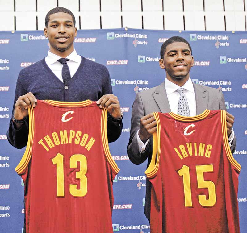 Tristan Thompson, left, and Kyrie Irving hold up Cleveland Cavaliers jerseys, Friday, June 24, 2011, in Independence, Ohio. Irving was the No. 1 overall pick in the 2011 NBA basketball draft and Thompson was the No. 4 overall pick. (AP Photo/Tony Dejak)