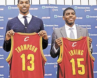 Tristan Thompson, left, and Kyrie Irving hold up Cleveland Cavaliers jerseys, Friday, June 24, 2011, in Independence, Ohio. Irving was the No. 1 overall pick in the 2011 NBA basketball draft and Thompson was the No. 4 overall pick. (AP Photo/Tony Dejak)