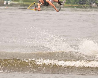    Local Wake Board Professional Rob Struharik from Youngstown, OH performs an air trick on his CWB board at the 5th Annual Wake Milton (OK) 2011 held at Lake Milton State Park.  Rob was one of the many wake boarders who participated in this year's tournament.  Struharik is sponsored by CWB and Roswell.  The event was organized by Dan Stone of Water's Edge Board Shop in Lake Milton, OH. All ages competed in four divisions.  The event was sponsored by Hyperlite, Boat House Marine, and Mastercraft...LINDSAY MCCALL | THE VINDICATOR