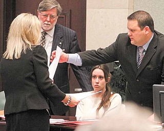 Casey Anthony, seated center, listens to counsel, including Prosecutor Linda Drane-Brudick, left, Cheney Mason, defense, second from left, and Wil Slabaugh, before the start of court during day 18 of her murder trial at the Orange County Courthouse, in Orlando, Fla., Tuesday, June 14, 2011.  Anthony, 25,  is charged with killing her 2-year old daughter in 2008.(AP Photo/Red Huber,Pool)