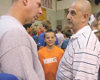 Bo Pelini Nebraska Coach talks with Karl Scheetz and his son Luke 11, of New Springfield after Mooney's Camp of Champions. 