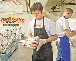 Frank Gazella, Jr., left, and Andrew Misak, co-owners of Pieroguys Pierogies, work on packaging pierogies for delivery at their City Market shop in Kansas City, Missouri onThursday, December 2, 2011. (Allison Long/Kansas City Star/MCT)