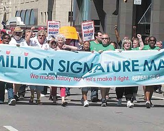Opponents of Senate Bill 5 lead a parade through downtown Columbus to the Secretary of State’s Office
on Wednesday to turn in nearly 1.3 million petition signatures seeking to repeal Ohio’s controversial collective bargaining law.