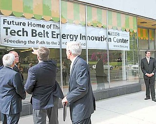 Warren Mayor Michael O’Brien and others involved in the Tech Belt Energy Innovation Center check out the new sign for the center, a 37,000-square-foot building near Courthouse Square in downtown Warren. A ceremony to unveil the space took place Wednesday.