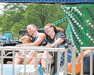 Tom and Shannon Semple of Liberty ride the Twister with their 5-year-old daughter, Mia. The fair runs through Monday.