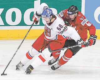 FILE - In this May 18, 2010 file photo, Czech Republic's Jaromir Jagr, left, stick handles the puck away from Team Canada's Rich Peverley during second period action at the IIHF World Hockey Championship in Mannheim, Germany. Petr Svoboda, Jagr's agent, said Tuesday, June 2,1 0211, that he has been talking to the Detroit Red Wings and Pittsburgh Penguins about the Czech star returning to the NHL. Jagr hasn't played in the NHL since the 2007-08 season with the New York Rangers. (AP Photo/The Canadian Press, Jacques Boissinot, File)