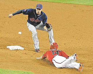 Arizona Diamondbacks' Ryan Roberts (14) steals second base as Cleveland Indians' Asdrubal Cabrera waits for the ball during the second inning in an interleague baseball game on Wednesday, June 29, 2011, in Phoenix. (AP Photo/Ross D. Franklin)