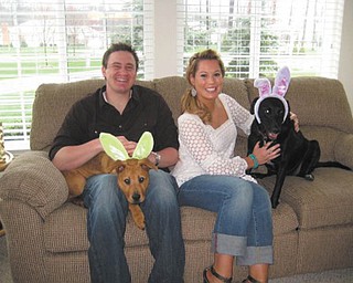 Steve and Cathy Ferenchak of Canfield sent this picture of their two "grandpups." Their daughter, Angie Ferenchak of Westlake, adopted Cali (the black Lab ) from a shelter three years ago and little Yashu (the brown Chow ) this year. Joining in on their Easter fun is Angie's boyfriend, John Bialowas, also of Westlake.