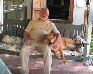Jerry Hoover of Boardman is relaxing with his "granddog," Bullseye, who was adopted from Mahoning County Dog Pound.