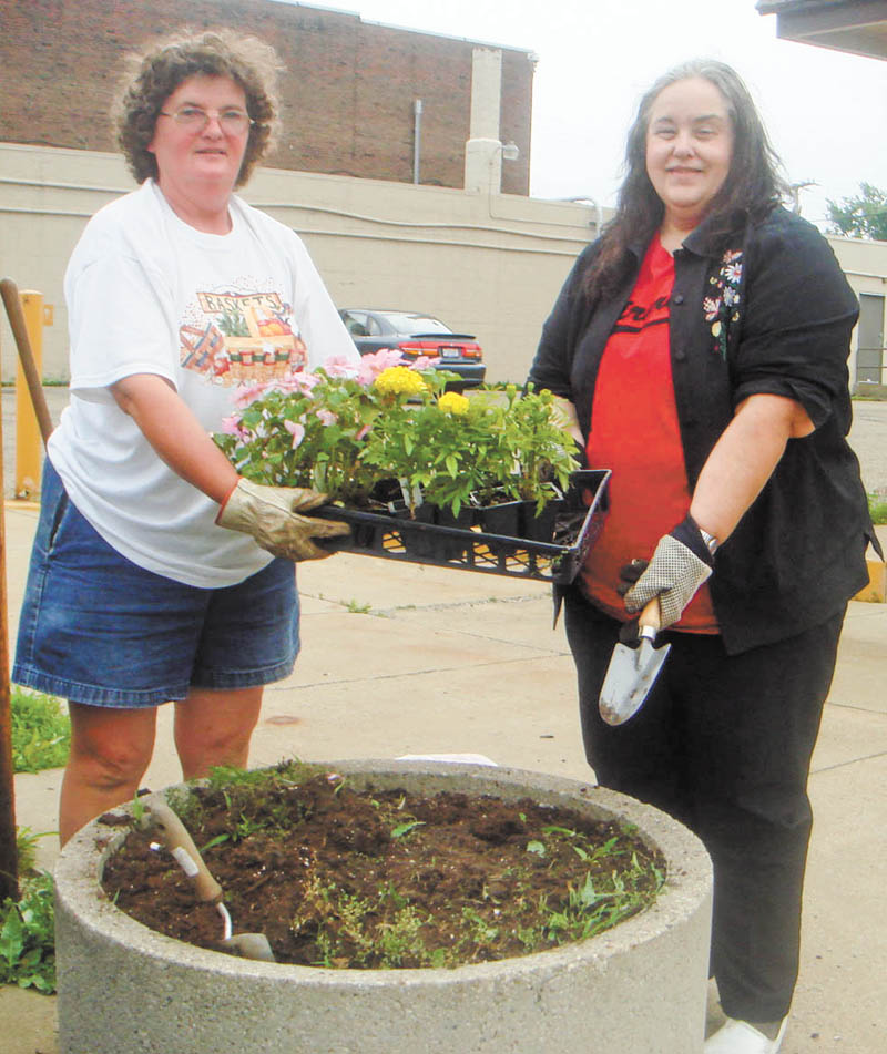Beautification project: Roberta Lawrentz, left, and Sue Ellen Davis of Girard Junior Women’s Club fill a planter in downtown Girard. The annual project was initiated by Davis’s mother, Jane Harris. Planters in front of businesses are filled with flowers every summer as one of the group’s projects. Girard Junior Women are dedicated to serving the Girard community and most recently donated to Emmanuel House and presented a Girard graduate with scholarship money. Anyone interested in joining should contact Lawrentz or any member of GJWC.